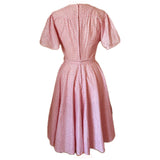 Pink cotton belted 1970s-does-1950s full circle dress with flutter sleeves