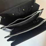 Black patent 1960s mod vintage handbag with abstract buckle detail
