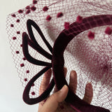 Dramatic 1950s burgundy velvet sculpted vintage halo cocktail hat with veil