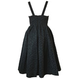 Sultry black late 1950s cocktail dress with interconnecting rings pattern